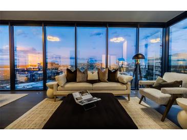 Bright living room boasts floor-to-ceiling windows with amazing city views and modern decor at 788 W Marietta Nw St # 1302, Atlanta, GA 30318