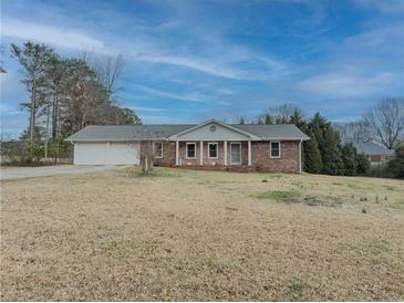 Charming brick ranch home with a large front yard and attached two-car garage at 772 Garner Sw Rd, Lilburn, GA 30047