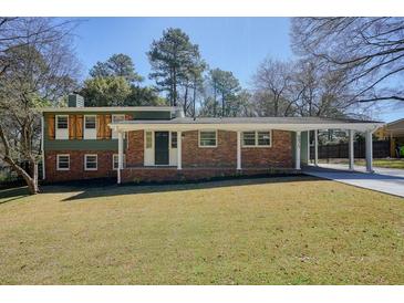 Charming two-story home with brick facade, covered entry, and spacious front yard on a sunny day at 6875 Sunny Brook Ln, Atlanta, GA 30328