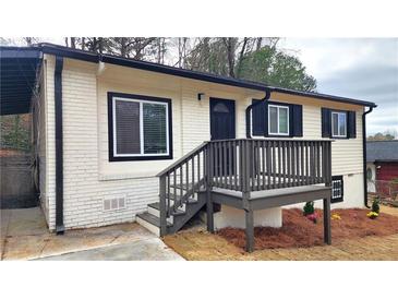 Charming home featuring a quaint front porch and a combination of brick and vinyl siding at 2232 Addison Nw Pl, Atlanta, GA 30318