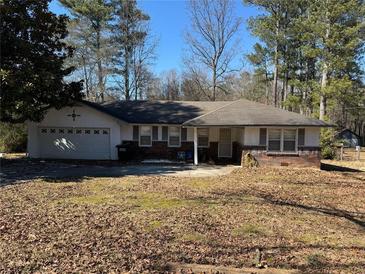 Charming single-story home with a brick facade and a well-maintained front yard at 614 Hunnicutt Se Rd, Mableton, GA 30126