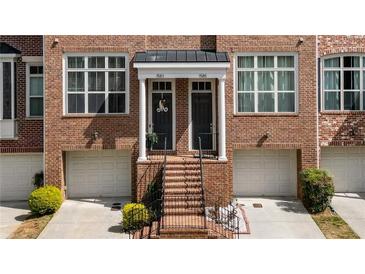 Charming brick townhome with inviting entrance, classic architectural details and attached garages at 1583 Mosaic Way, Smyrna, GA 30080