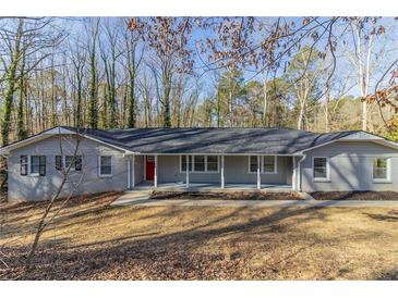 Charming ranch-style home with a welcoming porch and mature trees in a peaceful neighborhood at 5845 Highway 92, Fairburn, GA 30213