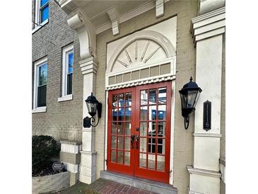 Stunning red double front door with decorative transom and sconces, adding charm and curb appeal at 1116 Piedmont Ne Ave # 12, Atlanta, GA 30309