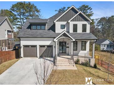 Beautifully designed home with a two-car garage and an inviting entrance, exuding modern elegance at 1857 Defoor Ave, Atlanta, GA 30318