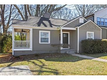 Charming single-story home with a covered front porch and well-maintained landscaping at 1600 Temple Ave, Atlanta, GA 30337
