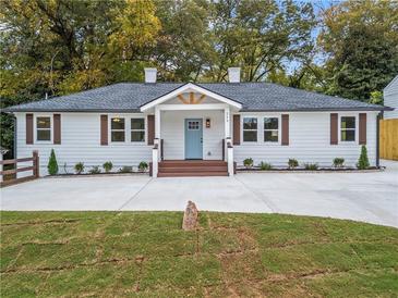 Charming renovated ranch with blue front door, new landscaping and a large driveway at 253 Mcintosh Avenue Ne, Marietta, GA 30060