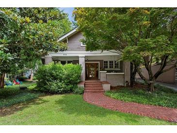 Charming home with a brick walkway leading to the front door and lush landscaping at 996 Blue Ridge Ne Ave, Atlanta, GA 30306