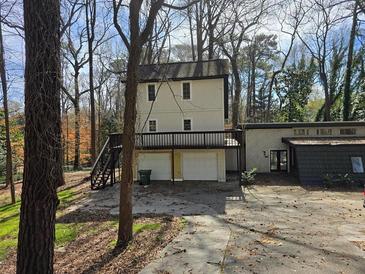 Unique two-story home with a two-car garage, deck, and driveway at 1920 Moores Mill Nw Rd, Atlanta, GA 30318