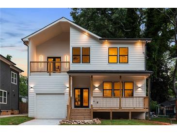 Charming two-story home featuring a covered porch and a second-story balcony for added outdoor enjoyment at 61 Newcastle Sw St, Atlanta, GA 30314