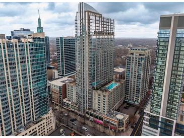 Stunning high-rise condo building with modern architecture and a rooftop pool in a vibrant city setting at 855 Peachtree Ne St # 1911, Atlanta, GA 30308