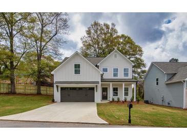 Charming two-story home with a well-manicured lawn and a two-car garage at 2949 Jefferson St, Austell, GA 30106