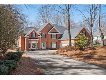 Charming brick home with a well-manicured lawn and a spacious driveway; a welcoming sight for potential buyers at 760 Valley Summit Drive, Roswell, GA 30075