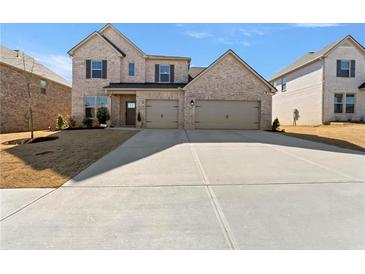 Charming two-story home with a well-manicured lawn and a three car garage at 2286 Cadenza Cir, Dacula, GA 30019