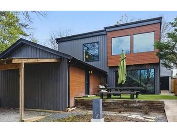 Contemporary exterior with mixed materials, including siding and wood accents, with a picnic table in the backyard at 1742 Ridgeway Nw Ave, Atlanta, GA 30318