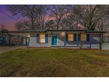 Charming single-story brick home with blue shutters, freshly painted and landscaped yard at 1496 Greenwillow Dr, Conley, GA 30288