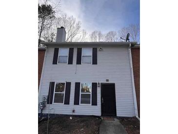 Charming home showcasing a well-maintained exterior and inviting entrance with a black front door at 5609 Windwood Rd, Atlanta, GA 30349