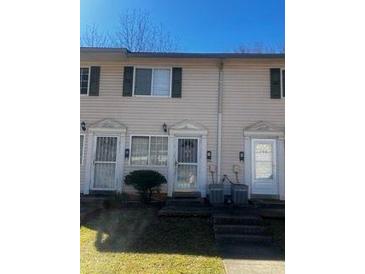 A townhouse exterior with a yard, window, and visible entryway at 405 Fairburn Sw Rd, Atlanta, GA 30331