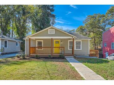 Charming single-story home featuring a welcoming front porch and a neatly manicured lawn at 1532 Pineview Sw Ter, Atlanta, GA 30311