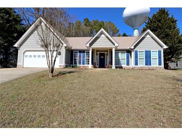Charming ranch-style home with gray siding, blue shutters, and a well-manicured front lawn at 67 Mossy Oak Ln, Dallas, GA 30157