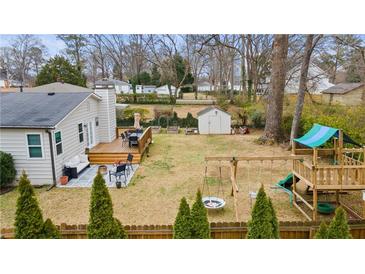 Spacious backyard features a deck, patio, play area, shed, and a well-maintained lawn, perfect for outdoor activities and relaxation at 1060 Mclinden Se Ave, Smyrna, GA 30080