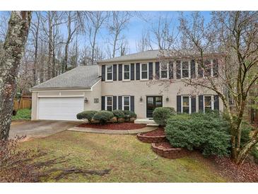 Charming two-story brick home with attached two-car garage and manicured front yard landscaping at 2795 Kakki Ct, Marietta, GA 30062