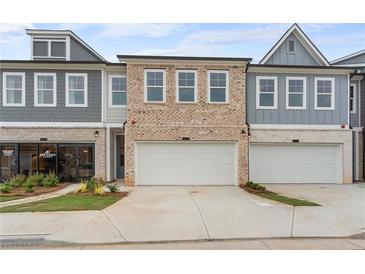 Beautiful townhome exterior featuring brick and siding with a two-car garage and modern architectural details at 1024 Rose Dr, Marietta, GA 30060
