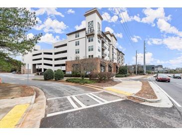 Attractive apartment building exterior with balconies, street views, and adjacent parking garage at 901 Abernathy Ne Rd # 3220, Sandy Springs, GA 30328