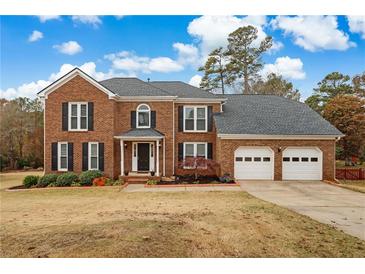 Beautiful two story brick home with a two car garage and manicured lawn at 2607 Westchester Se Pkwy, Conyers, GA 30013