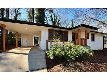 Charming renovated brick home with a covered carport, wooden porch, and freshly landscaped front yard at 3147 Bellgreen Way, Decatur, GA 30032