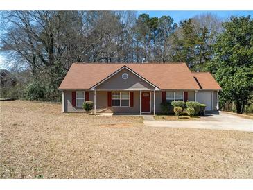 Charming single-story home with a cozy front porch, brown roof, and manicured landscaping at 131 Tye St, Stockbridge, GA 30281