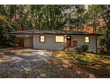 Charming single-story home featuring a carport, landscaped front yard, and freshly painted exterior at 3113 Bellgreen Way, Decatur, GA 30032