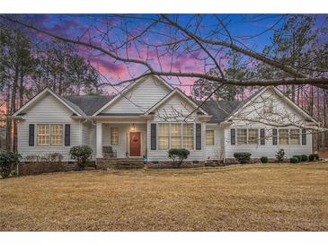 Charming single Gathering home with red front door and white painted wood facade and dark shutters at 9369 Kraft Dr, Winston, GA 30187