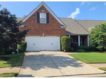 Charming brick home with a two-car garage and well-maintained landscaping at 352 Lauren Ln, Woodstock, GA 30188