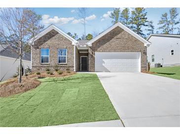 Charming single-story home with a well-maintained lawn, brick facade, and two-car garage at 159 Park Lane Ln, Fairburn, GA 30213