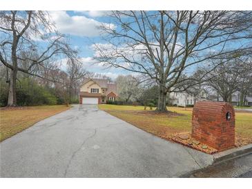 Charming two-story home with a brick mailbox, spacious driveway, and a well-manicured lawn at 381 Gates Mil Dr, Lawrenceville, GA 30045