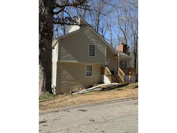 Charming house featuring a quaint porch and a classic brick chimney at 653 Inland Way, Lilburn, GA 30047