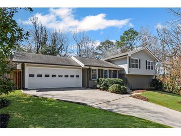Charming home with a two-car garage, beautifully landscaped front yard, and inviting curb appeal at 260 Mansell Cir, Roswell, GA 30075