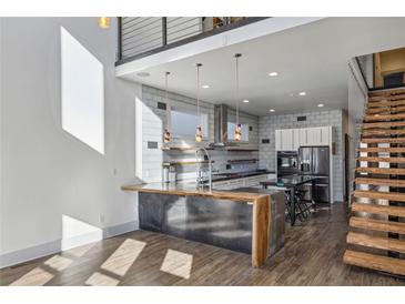 Modern kitchen features a large island, stainless steel appliances, and an open layout with wood floors at 560 John Wesley Dobbs Ave, Atlanta, GA 30312