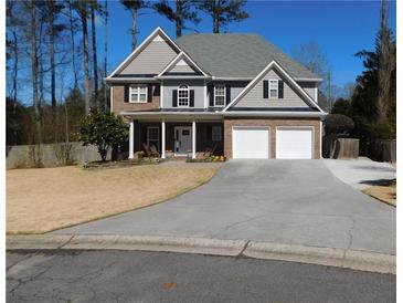 Charming two-story home with a well-maintained lawn, a two-car garage, and a welcoming front porch at 4845 Dartford Dr, Powder Springs, GA 30127
