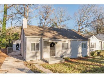 Charming single-story home featuring a brick chimney, updated windows and a covered front porch at 1376 Westmont Sw Rd, Atlanta, GA 30311