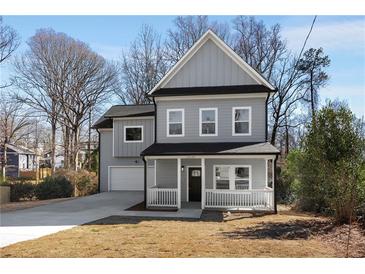 Charming gray two-story home with a welcoming front porch and well-manicured lawn at 2150 Essex Sw Ave, Atlanta, GA 30311