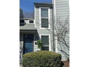Two story home featuring a dark blue front door and light grey siding at 1063 Riverbend Club Se Dr, Atlanta, GA 30339