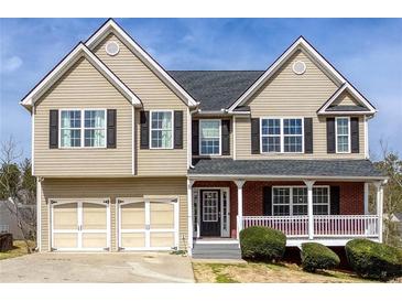 Charming two-story home with a two-car garage, covered front porch, and manicured landscaping at 203 Overlook Ct, Dallas, GA 30157