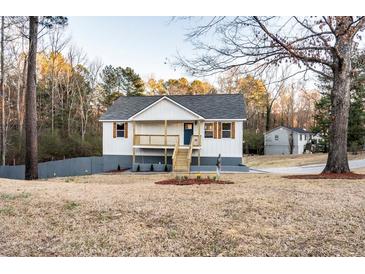 Charming, newly renovated two-story home featuring a welcoming front porch and beautifully landscaped front yard at 1919 Pair Sw Rd, Marietta, GA 30008