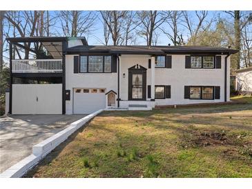 Charming white brick home with black trim and a spacious front yard at 441 Windsor Dr, Forest Park, GA 30297
