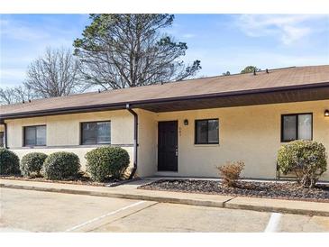Inviting exterior with manicured bushes, neutral paint, and marked parking spots at 803 New Horizon St, Powder Springs, GA 30127
