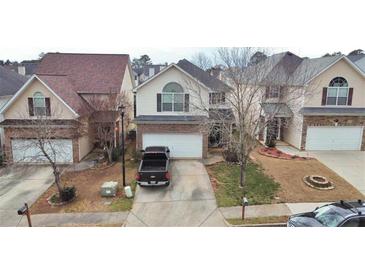 Charming two-story home with a brick facade and well-maintained front yard at 11169 James Madison Dr, Hampton, GA 30228
