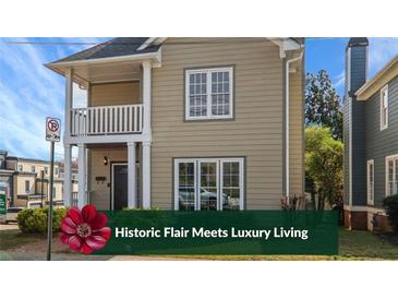 Charming two-story home featuring a quaint porch, neutral siding and double-pane windows at 484 Martin Se St, Atlanta, GA 30312
