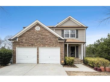 Charming two-story home featuring a stacked stone front and a two car garage at 665 Sable View Ln, Atlanta, GA 30349